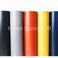 Rollos de linóleo en colores negro, gris, naranja, amarillo y azul